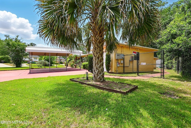exterior space featuring a yard, fence, and a gate