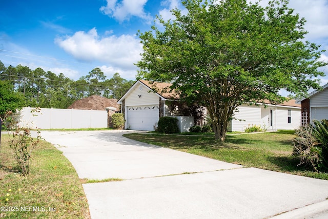 obstructed view of property featuring a front lawn, driveway, a garage, and fence