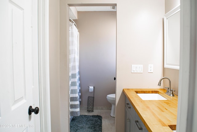 full bathroom with a shower with curtain, toilet, tile patterned flooring, and vanity