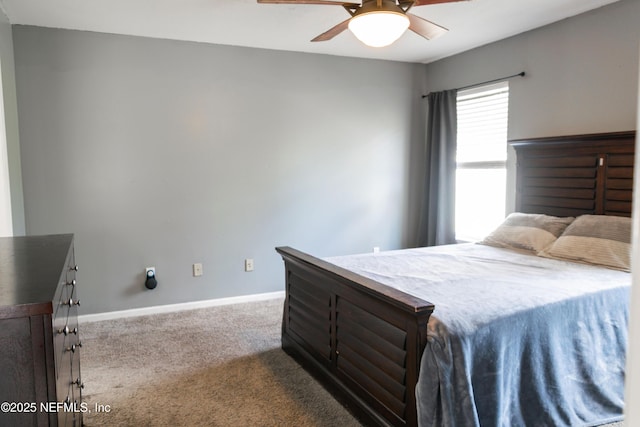 carpeted bedroom featuring baseboards and ceiling fan