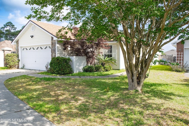 view of front facade with a garage, a front lawn, driveway, and roof with shingles