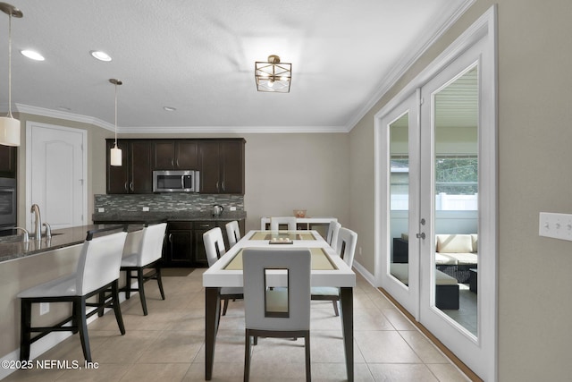 11459 Glenlaurel Oaks Cir, Jacksonville, FL 32257 - dining area featuring light tile patterned floors, crown molding, recessed lighting, and french doors