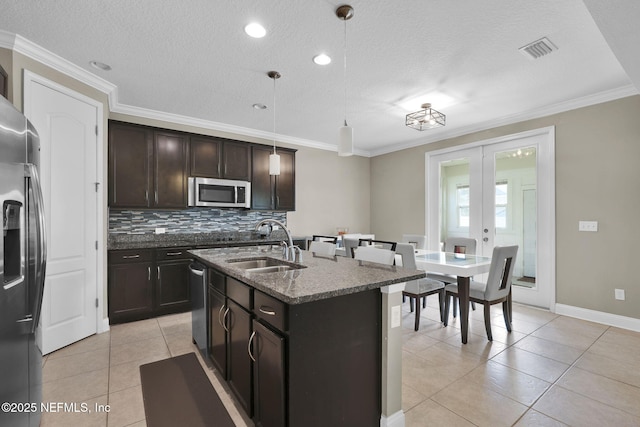 11459 Glenlaurel Oaks Cir, Jacksonville, FL 32257 - kitchen featuring a sink, light tile patterned flooring, backsplash, a textured ceiling, and appliances with stainless steel finishes