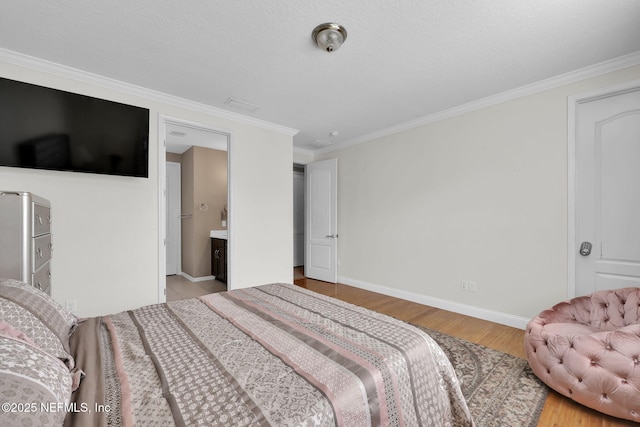 11459 Glenlaurel Oaks Cir, Jacksonville, FL 32257 - bedroom with wood finished floors, ensuite bathroom, crown molding, and baseboards