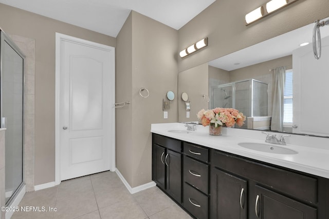 11459 Glenlaurel Oaks Cir, Jacksonville, FL 32257 - bathroom featuring double vanity, a sink, a shower stall, and tile patterned floors