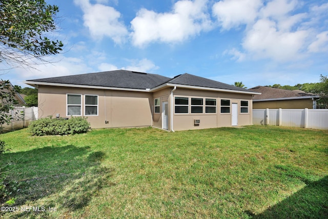 11459 Glenlaurel Oaks Cir, Jacksonville, FL 32257 - rear view of house with fence, roof with shingles, a yard, and stucco siding