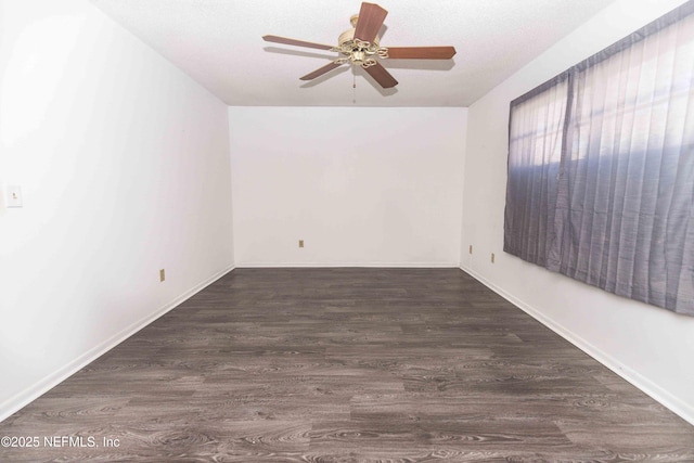 empty room featuring wood finished floors, ceiling fan, and baseboards