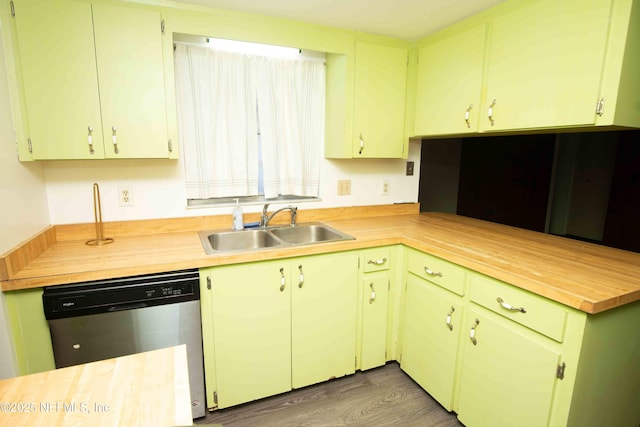 kitchen featuring wood finished floors, stainless steel dishwasher, butcher block countertops, and a sink