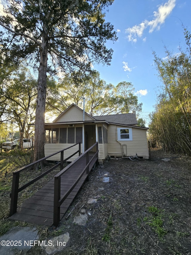 view of front facade with a sunroom