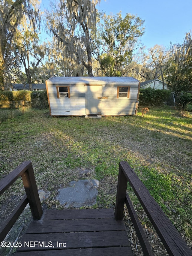view of yard with fence and an outdoor structure