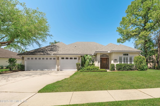 ranch-style home featuring a garage, stucco siding, a front yard, and concrete driveway