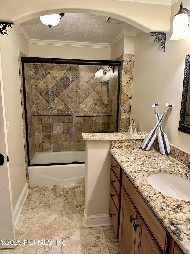 bathroom with baseboards, ornamental molding, bath / shower combo with glass door, and vanity