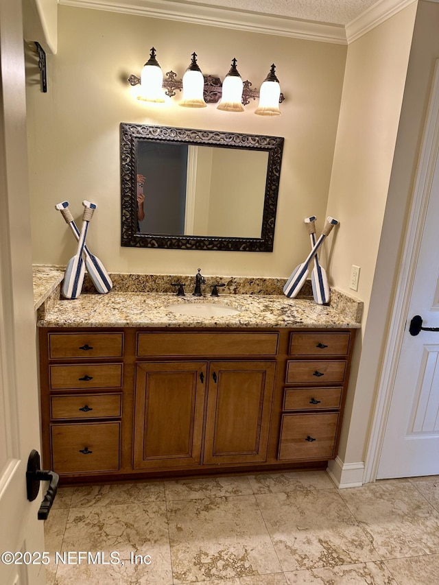 bathroom with crown molding and vanity