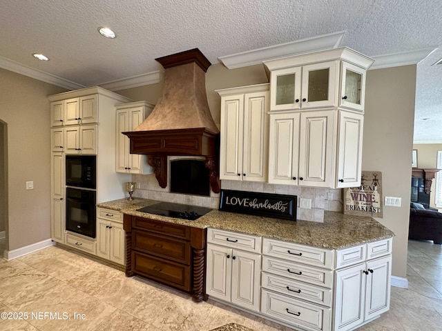 kitchen with backsplash, black appliances, glass insert cabinets, ornamental molding, and custom range hood