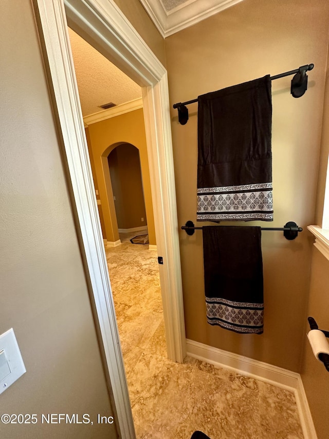 bathroom featuring crown molding, baseboards, and visible vents