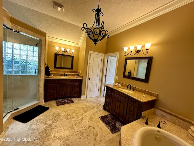 bathroom with a textured ceiling, crown molding, a stall shower, two vanities, and a sink