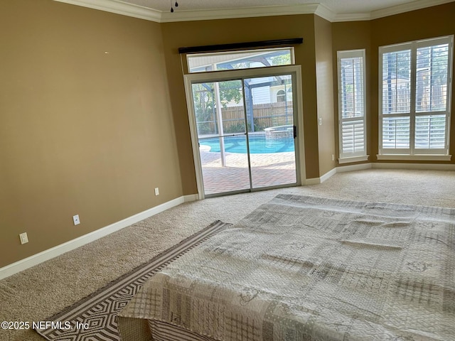 interior space with baseboards, ornamental molding, access to exterior, and light colored carpet
