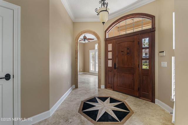 foyer entrance featuring baseboards and ornamental molding