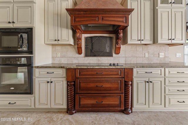 kitchen with light tile patterned flooring, cream cabinets, tasteful backsplash, light stone counters, and black appliances