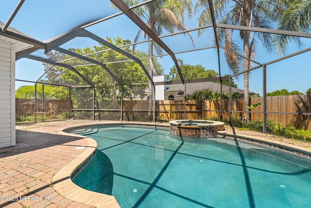 view of swimming pool featuring a patio, a fenced backyard, glass enclosure, and a pool with connected hot tub