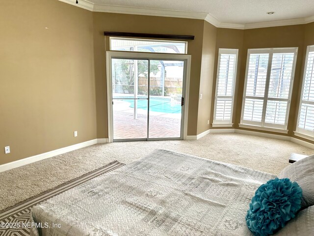 doorway to outside featuring baseboards, a healthy amount of sunlight, and carpet