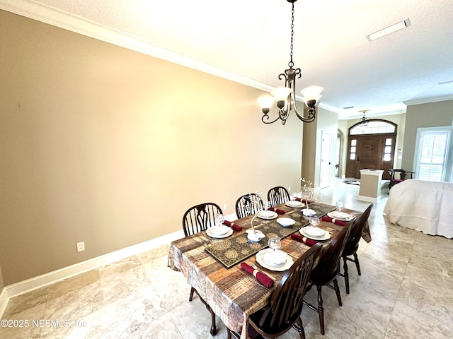 dining area featuring an inviting chandelier, ornamental molding, baseboards, and a textured ceiling