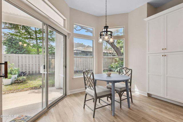 sunroom featuring an inviting chandelier