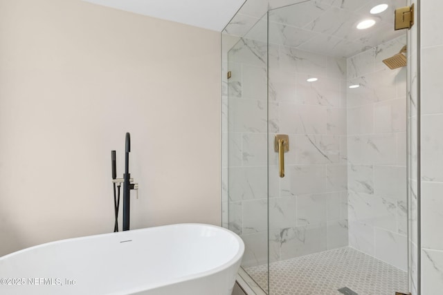 full bathroom with a freestanding bath and a shower stall