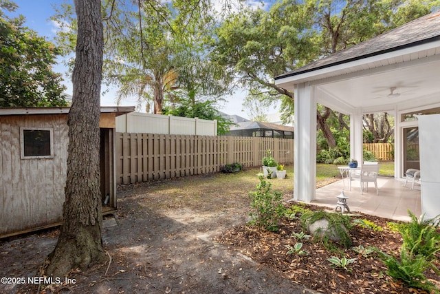 view of yard featuring a patio, a ceiling fan, and a fenced backyard