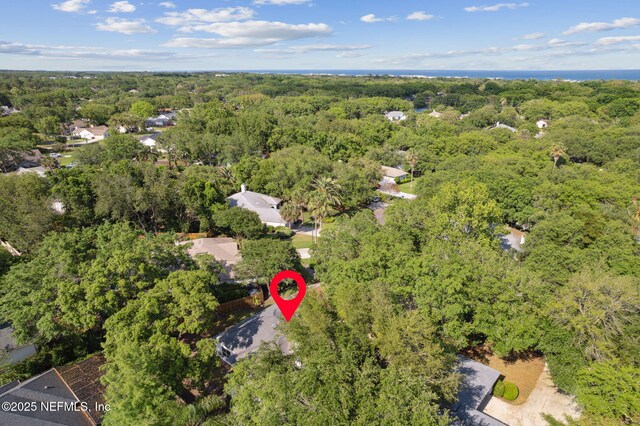 birds eye view of property with a forest view