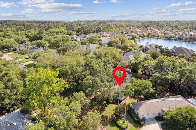 bird's eye view featuring a residential view, a water view, and a wooded view