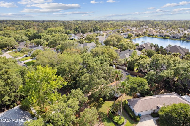 bird's eye view with a water view, a view of trees, and a residential view