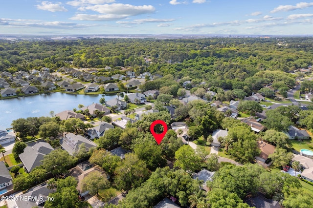 birds eye view of property featuring a wooded view and a residential view