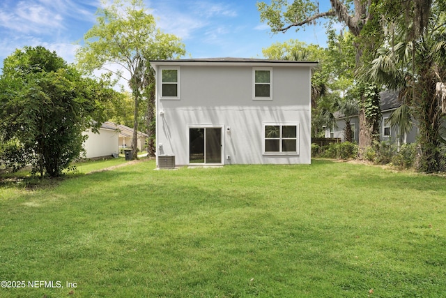 back of property featuring a lawn and cooling unit
