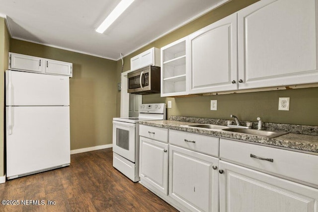 kitchen with white appliances, crown molding, white cabinets, and a sink