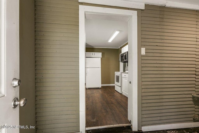 hall featuring dark wood-style floors and baseboards