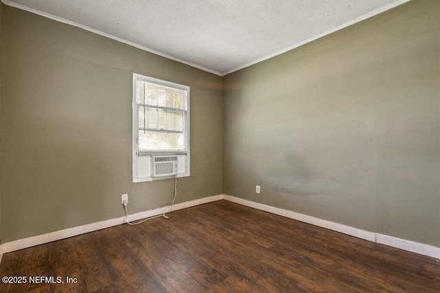 unfurnished room with dark wood-type flooring, crown molding, cooling unit, baseboards, and a textured ceiling