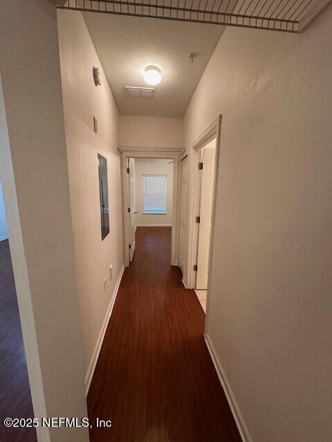 6860 Skaff Ave Unit 2-6, Jacksonville, FL 32244 - hallway with baseboards and dark wood-type flooring
