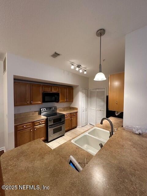 6860 Skaff Ave Unit 2-6, Jacksonville, FL 32244 - kitchen with range with two ovens, visible vents, black microwave, and a sink