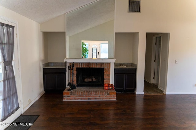 living room featuring visible vents, baseboards, wood finished floors, and high vaulted ceiling