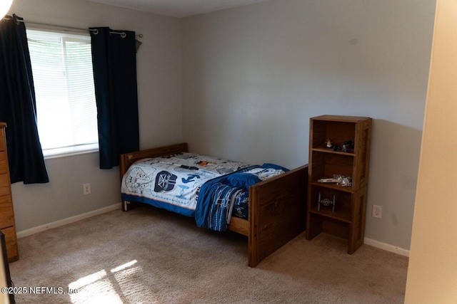 bedroom with baseboards, multiple windows, and carpet