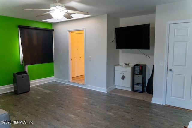 unfurnished bedroom featuring baseboards, ceiling fan, and wood finished floors