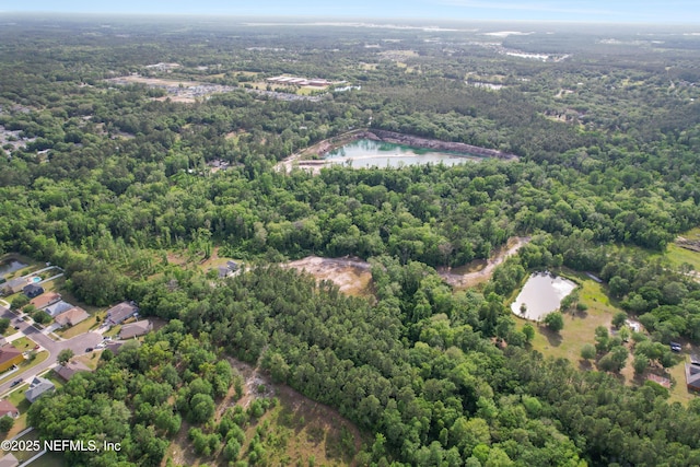 bird's eye view with a water view and a wooded view