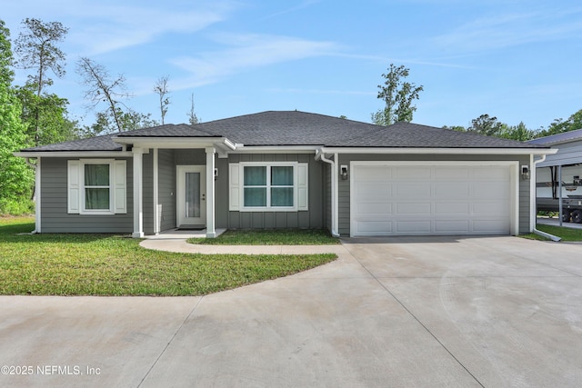 ranch-style house featuring a front lawn, roof with shingles, board and batten siding, concrete driveway, and an attached garage
