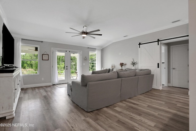 living room featuring crown molding, visible vents, wood finished floors, ceiling fan, and french doors