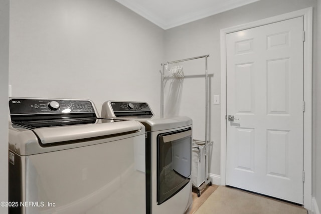 laundry room with crown molding, laundry area, and washer and clothes dryer