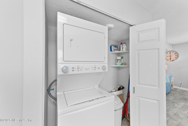 1711 2nd St N, Jacksonville Beach, FL 32250 - washroom with laundry area, a textured ceiling, and stacked washing maching and dryer