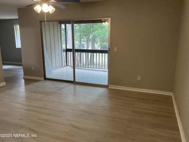 unfurnished room featuring baseboards, a ceiling fan, and wood finished floors