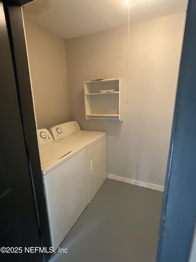 washroom featuring baseboards, laundry area, and washer and dryer