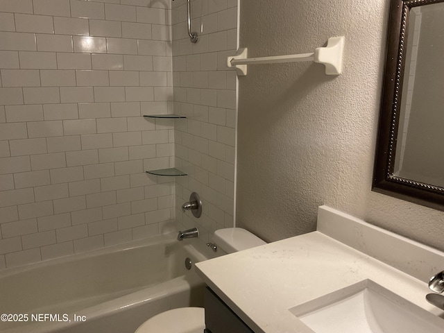 bathroom with shower / bathtub combination, a textured wall, vanity, and toilet